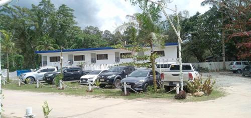 a group of cars parked in front of a house at Lopez Beach Resort in Sipalay
