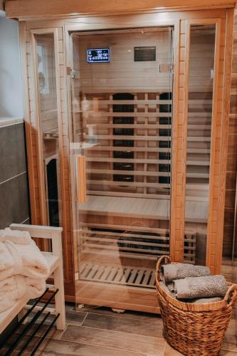 a shower with a glass door in a room at Cottage an der Elbe Tespe Hamburg in Tespe