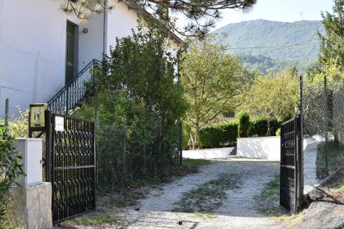a gate in front of a house with a driveway at The Lover House in Terni