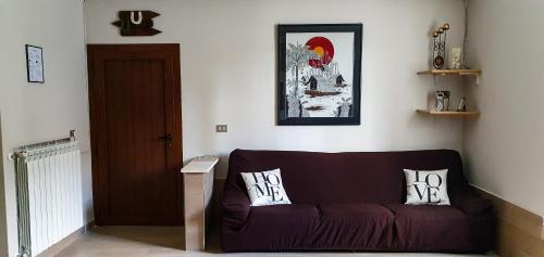 a living room with a couch with two pillows on it at The Lover House in Terni
