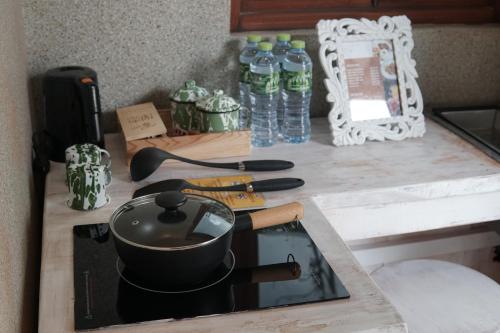 a kitchen counter with a stove with a pot on it at Dusun The Villas 