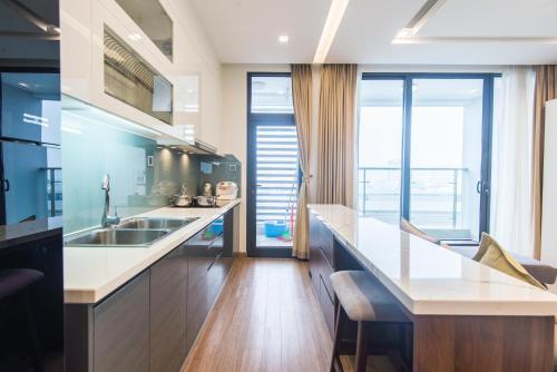 a kitchen with a sink and a counter top at Vinhomes Metropolis luxury Hotel & Residence in Hanoi