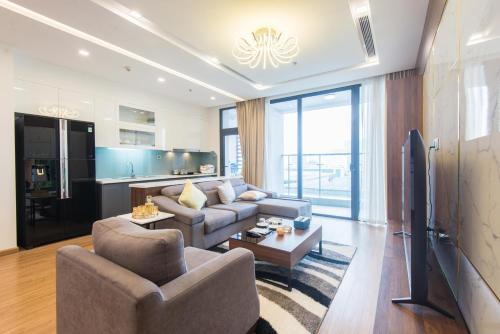 a living room with a couch and a tv at Vinhomes Metropolis luxury Hotel & Residence in Hanoi