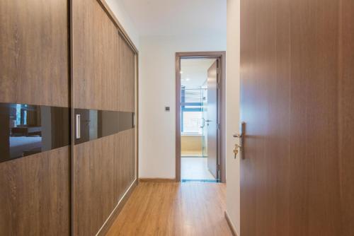 a hallway with wooden cabinets and a door at Vinhomes Metropolis luxury Hotel & Residence in Hanoi