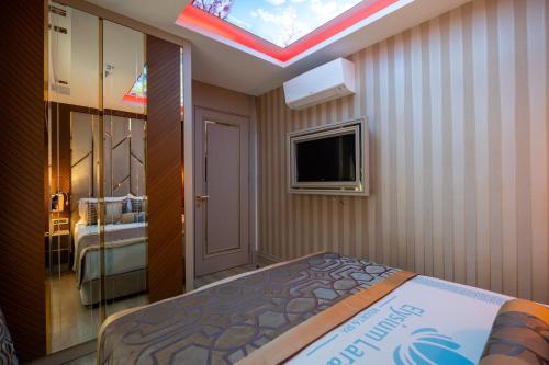 Ένα ή περισσότερα κρεβάτια σε δωμάτιο στο Elysium Deluxe Suites Antalya