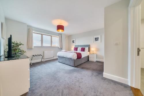 a bedroom with a bed and a television in it at Roomspace Serviced Apartments - The Courtyard Penthouse in London