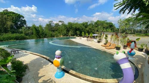 a swimming pool with toy figures in the water at Dusun The Villas 