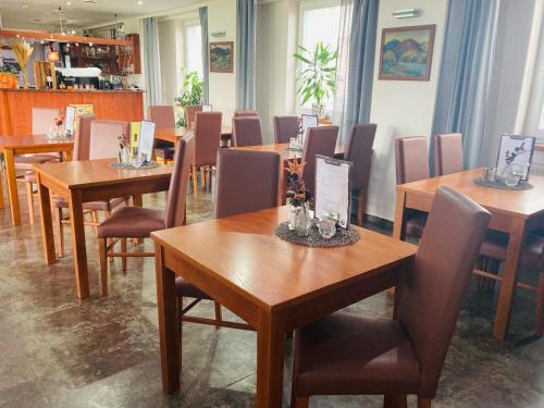 a dining room with wooden tables and chairs at Hotel 21 in Bratislava
