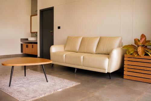 a living room with a couch and a table at Leaves Resort Vythiri Wayanad in Vythiri