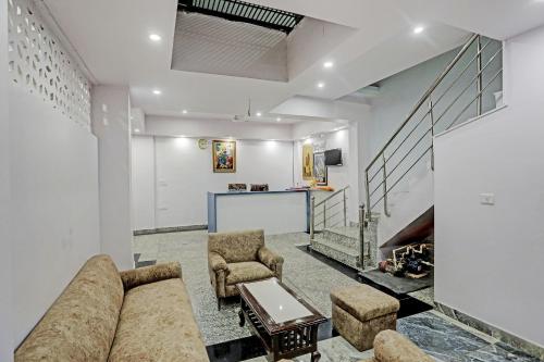 a living room with a couch and two chairs at Hotel S B INN Paharganj in New Delhi