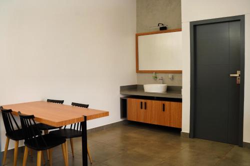 a kitchen with a wooden table and a sink at Leaves Resort Vythiri Wayanad in Vythiri