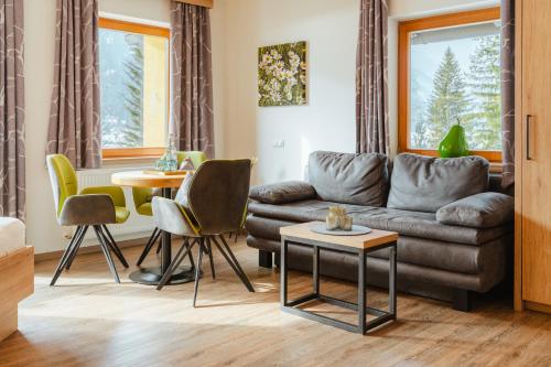 a living room with a couch and a table at Kamenhof in Weissensee