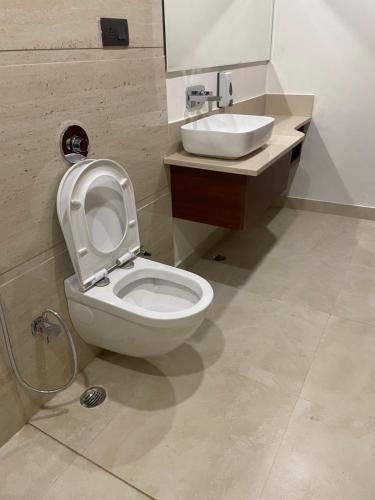 a bathroom with a toilet and a sink at The Kedar Resort in Mathura
