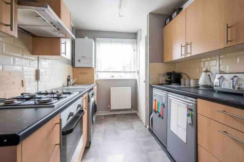 a large kitchen with a stove and a sink at Central London Spacious Double Room in London