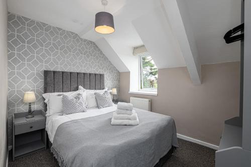a bedroom with a large bed and a window at Neigwl View in Llanfihangel Bachellaeth