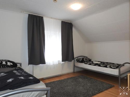 1 dormitorio con 2 camas y ventana en Wohnung nähe Daimler 1 OG en Bremen