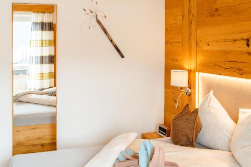 a living room with a couch and a mirror at Kamenhof in Weissensee