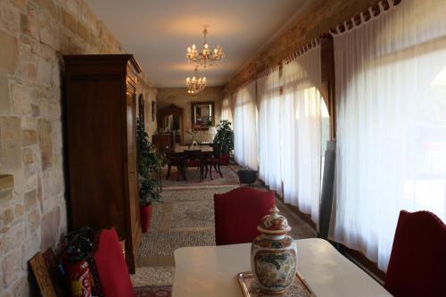 a room with a table and chairs and a dining room at CHATEAU DE SAINTE ORSE in Sainte-Orse