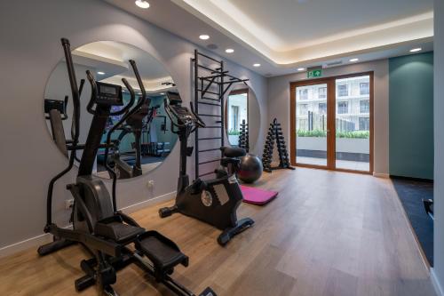 a gym with treadmills and exercise bikes in a room at RentPlanet - Apartamenty Zakopiańskie in Zakopane