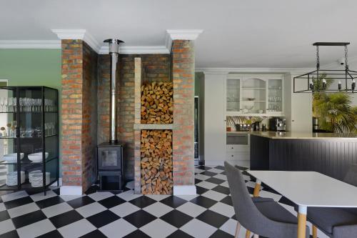 a living room with a fireplace and a stove at Fransvliet Guest House in Franschhoek