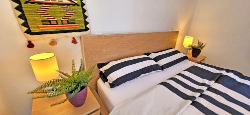 a bedroom with a bed with two striped pillows at Casa Perrito Gris in Playa Jandia