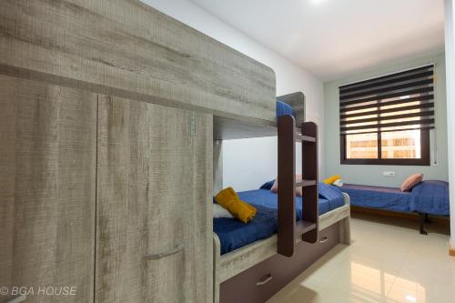a bedroom with two bunk beds with blue sheets at Bga Rentals Garbi in Cambrils