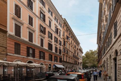 a street with cars parked next to tall buildings at Trastevere Delightful Apartment in Rome