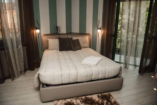 um quarto com uma cama grande com almofadas em Luxury experience in Alba: Unesco hills' hearth em Guarene