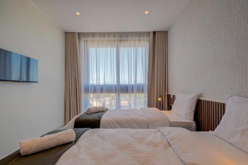 a hotel room with two beds and a window at Mayfair by Premier Suites MT in Is-Swieqi