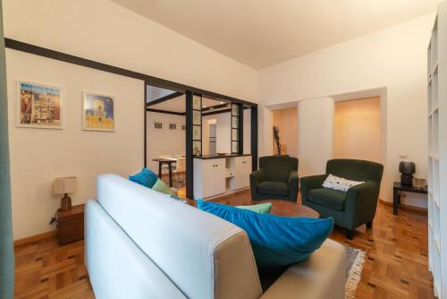 a living room with a couch and two chairs at Trastevere Delightful Apartment in Rome