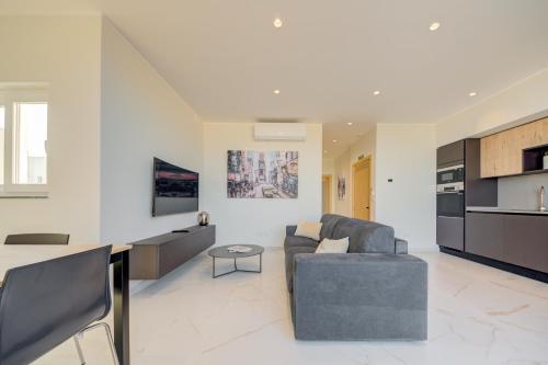 a living room with a couch and a table at Mayfair by Premier Suites MT in Is-Swieqi