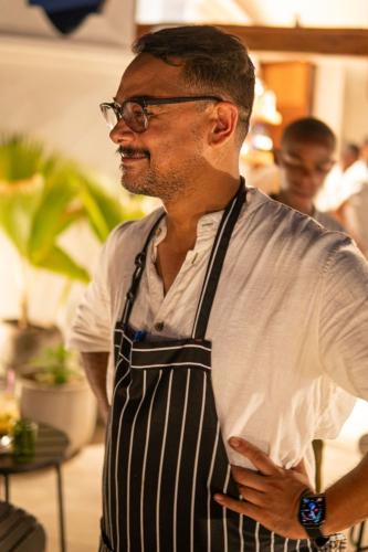 a man wearing an apron standing in a room at The Neela Boutique Hotel Stone Town in Zanzibar City