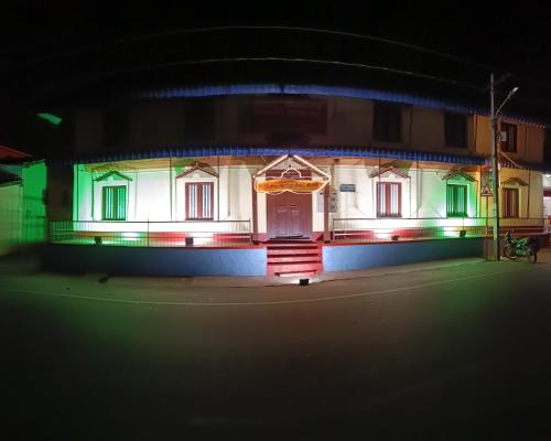 a house with lights on the front at night at Keshava Heritage in Belūr