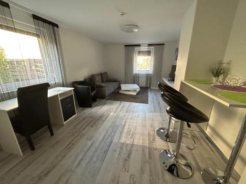 a living room with a couch and a table and chairs at Hotel Hasselberg in Kaiserslautern