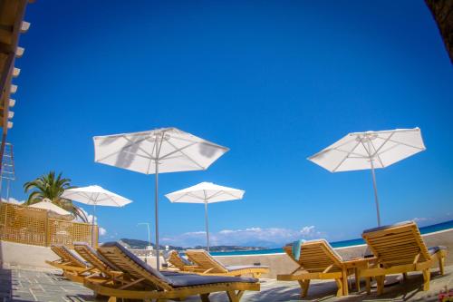 a group of chairs and umbrellas on a beach at Alas in Argasi