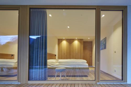 a bedroom with a view of a bed through a window at Greva Apartments 1 in Santa Cristina in Val Gardena