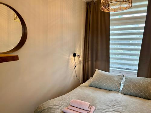 a bedroom with a bed with two towels on it at Amsterdam Beach Apartment 33, Private Garden in Zandvoort
