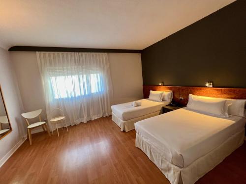 Un pat sau paturi într-o cameră la AP Hotel Madrid Airport