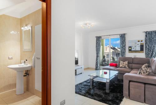 a living room with a couch and a table at Palm Mar Penthouse Duplex in Palm-mar