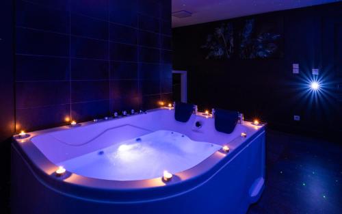a large bath tub with lights in a room at Suite Boréale 50m2 spa privatif. in Nancy
