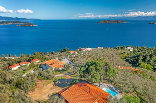 an aerial view of a house on a hill next to the water at Azul Boutique Home in Skiathos