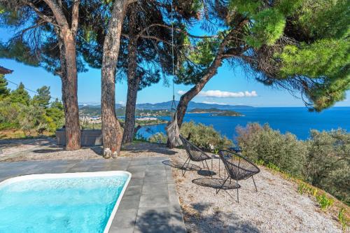 a view of the ocean from a house with two chairs at Azul Boutique Home in Skiathos