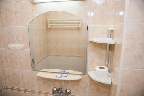 a bathroom with a shower with a sink and a mirror at Стаи за гости in Varna City