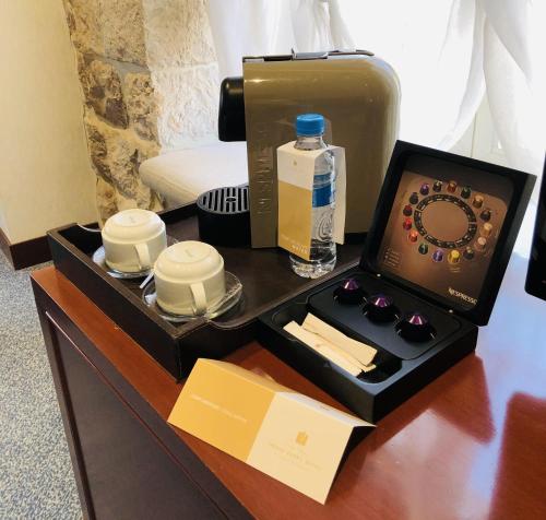 a hotel room with a tray with a bottle of water at Grand Kadri Hotel - History Marked by Cristal Lebanon in Zahlé