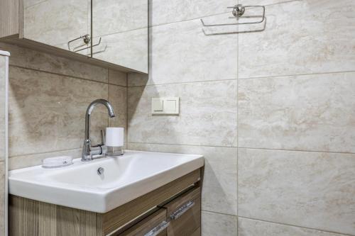 a bathroom with a sink and a shower at Flat with Terrace 1 min to Trump Towers in Istanbul