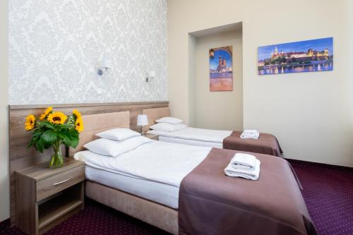Postel nebo postele na pokoji v ubytování Hotel Maximum