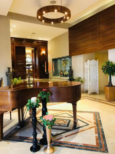 a living room with a piano in a room at Grand Kadri Hotel - History Marked by Cristal Lebanon in Zahlé