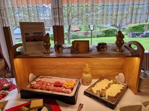 a display of food on a table in front of a window at Pension Grein in Pfunds