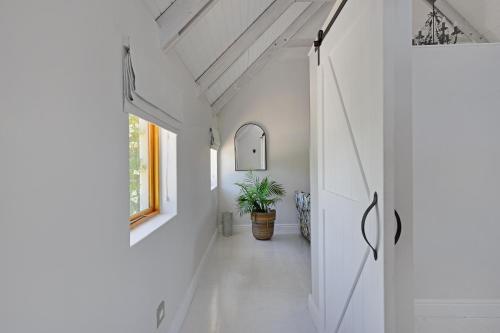 a hallway of a house with a potted plant at Fransvliet Guest House in Franschhoek