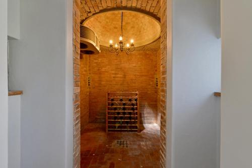 a hallway of a wine cellar with a chandelier at Fransvliet Guest House in Franschhoek